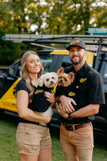 Critter Control of Springfield Staff Members in Front of Service Trucks